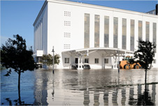 flood water damage outside of tall white austin office building action restoration