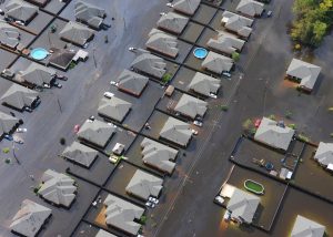 aerial view of neighborhood underwater homes and cars plants flooded