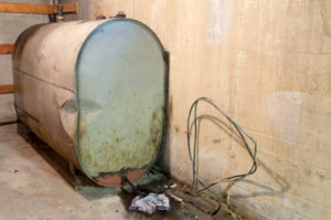 Old home heating oil tank in the basement of a residential home.