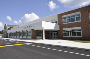 front of a school building with sunny sky behind it